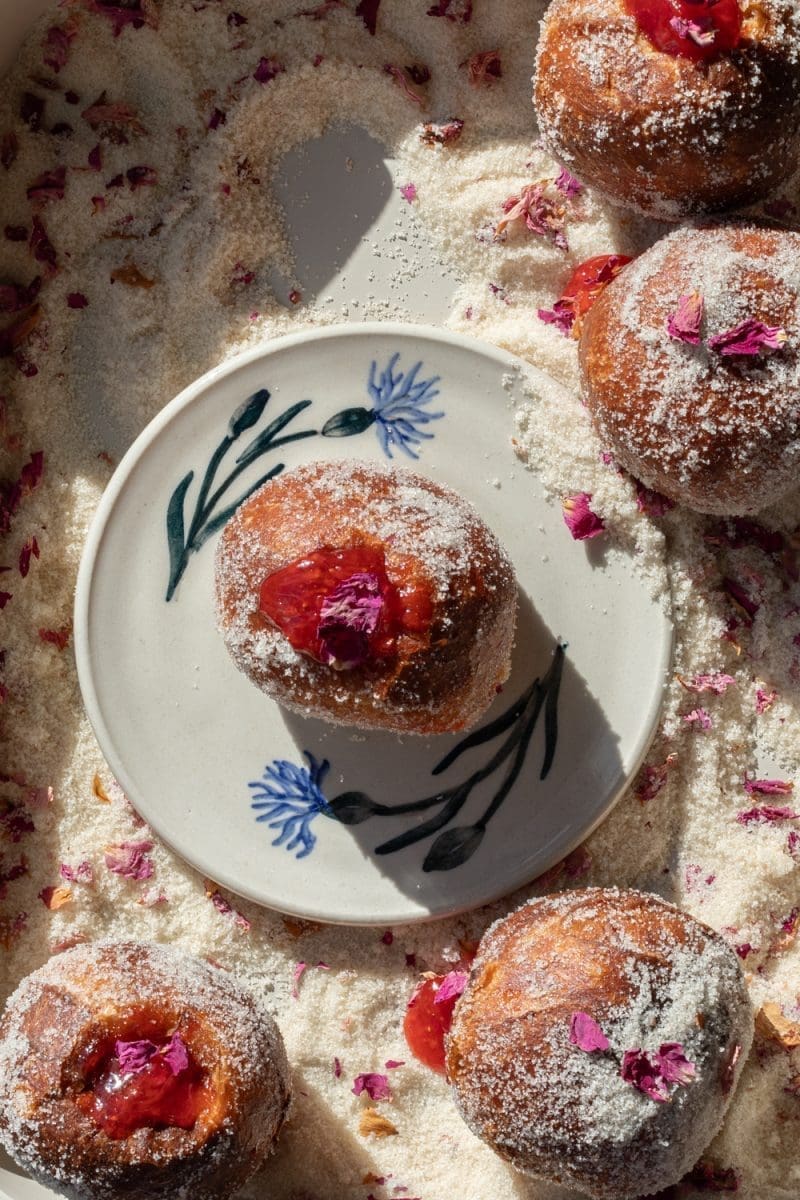 Close up of a filled strawberry rose paczki.