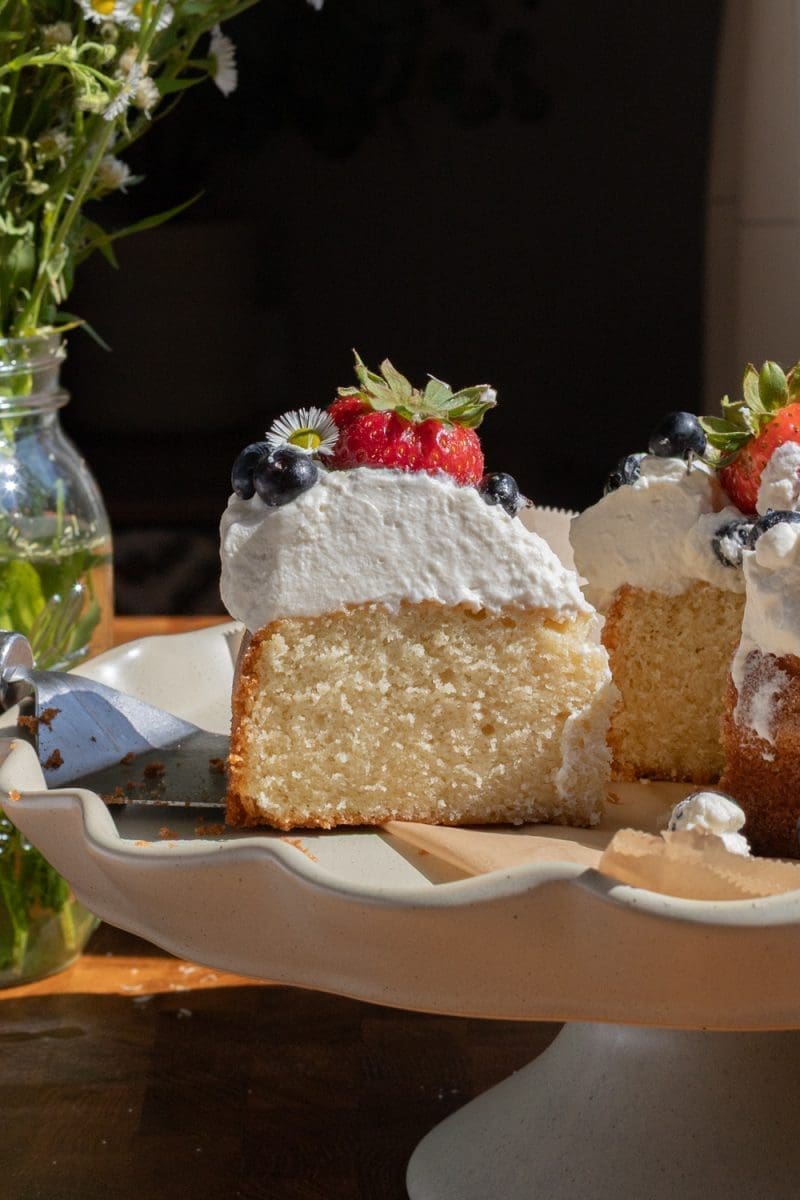 Close up of a slice of the berries and cream cake.