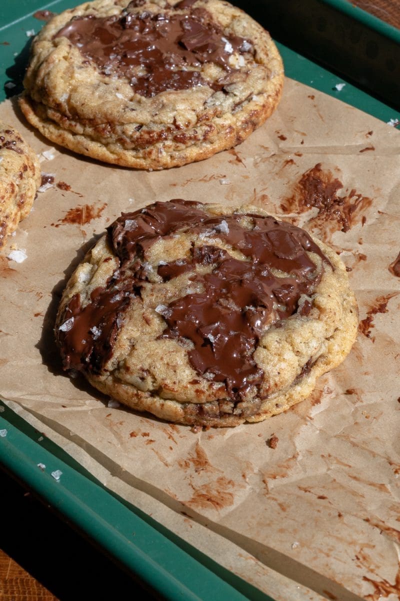 Close up angled view of a nutella stuffed chocolate chip cookie.