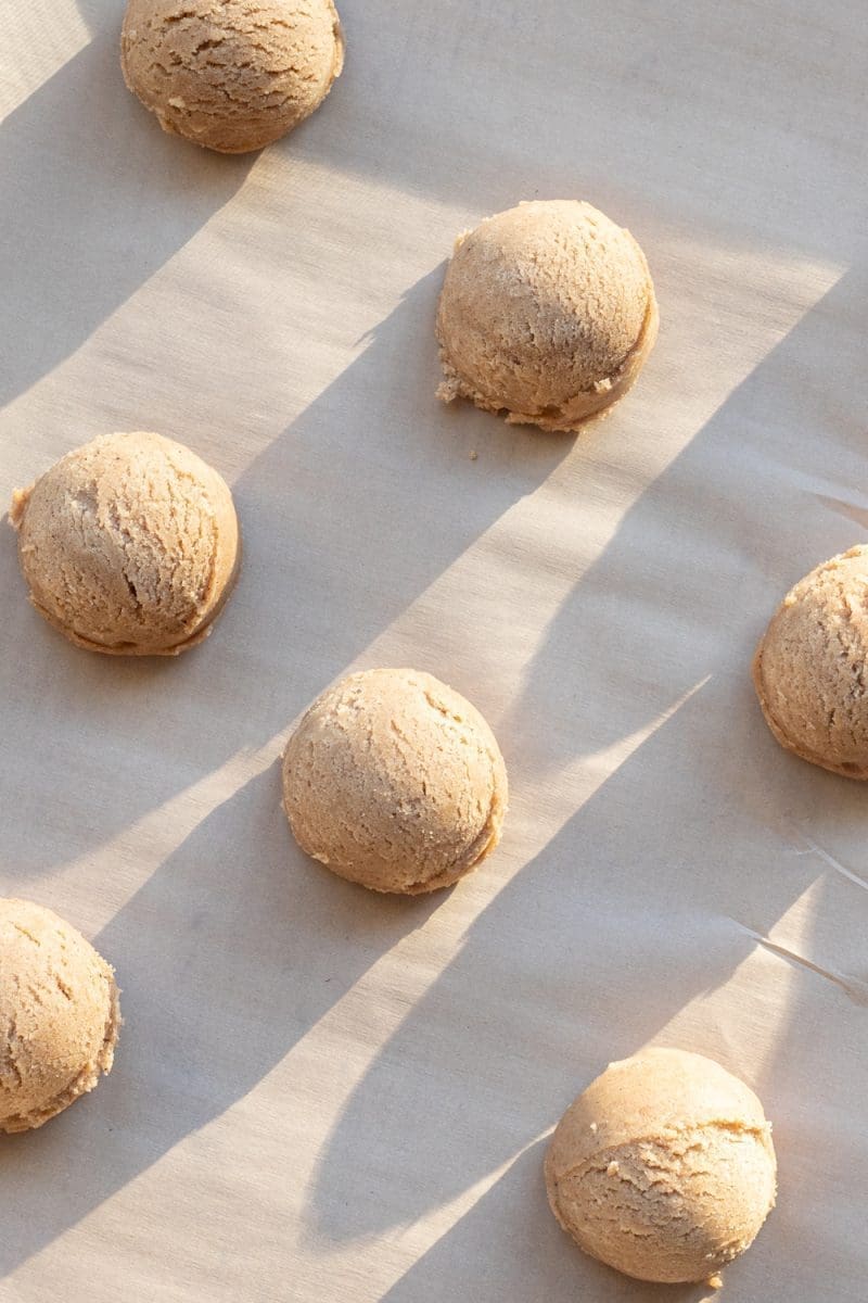Scooped out cookie dough on a baking tray.