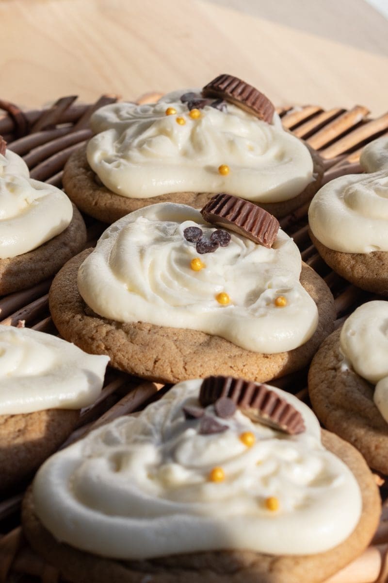 Angled close-up of the melting snowman cookies.
