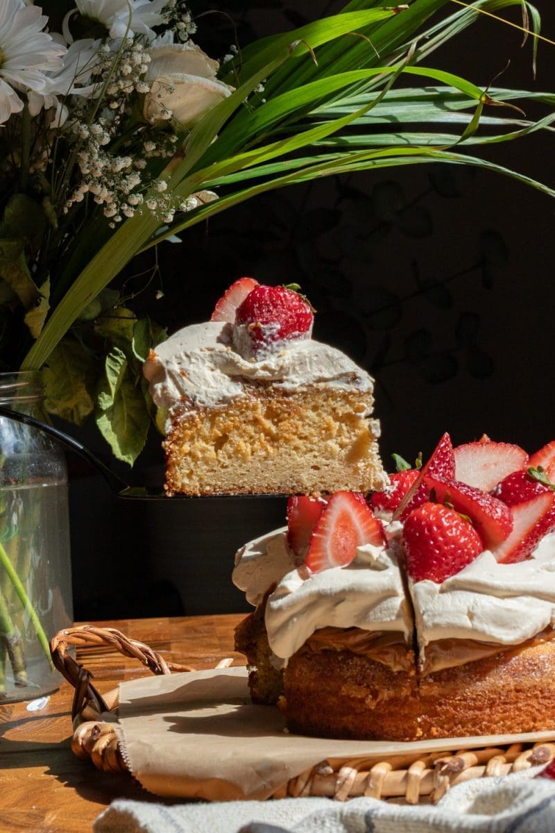 Holding up a slice of the dulce de leche strawberry shortcake.