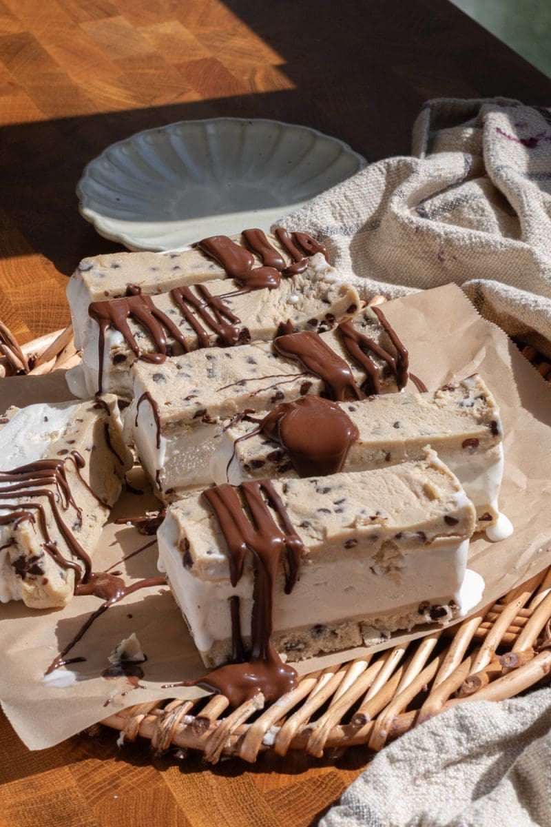 Cookie dough ice cream sandwiches sliced up on a serving tray.