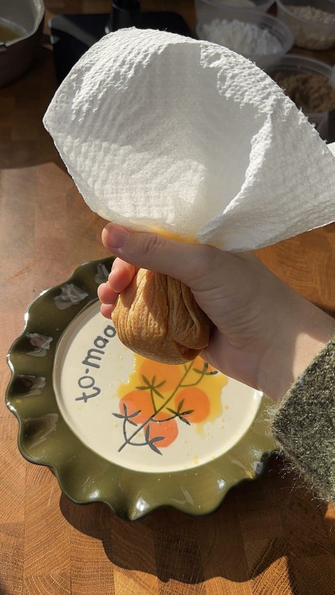 Squeezing moisture out of the pumpkin puree.