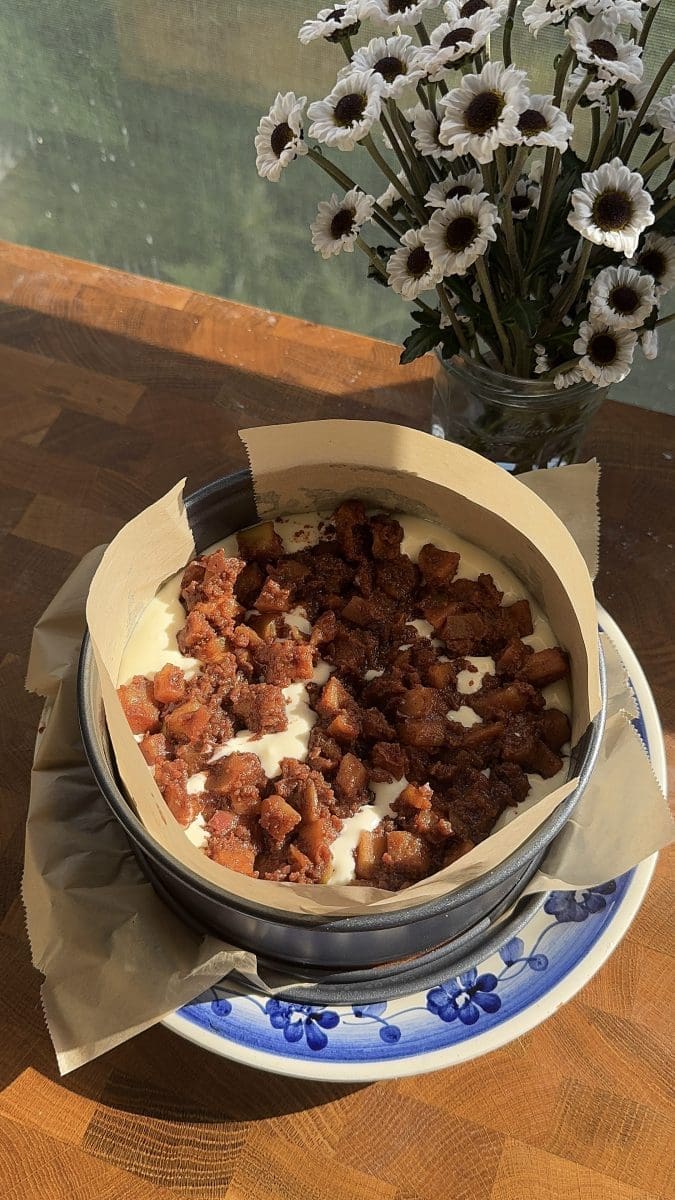 The apple pie filling on top of the cheesecake batter.