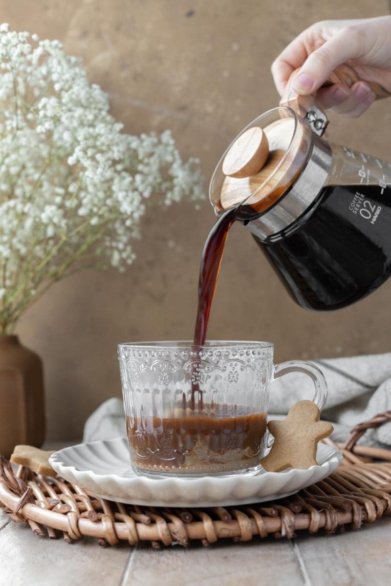 Pouring coffee into the cup.