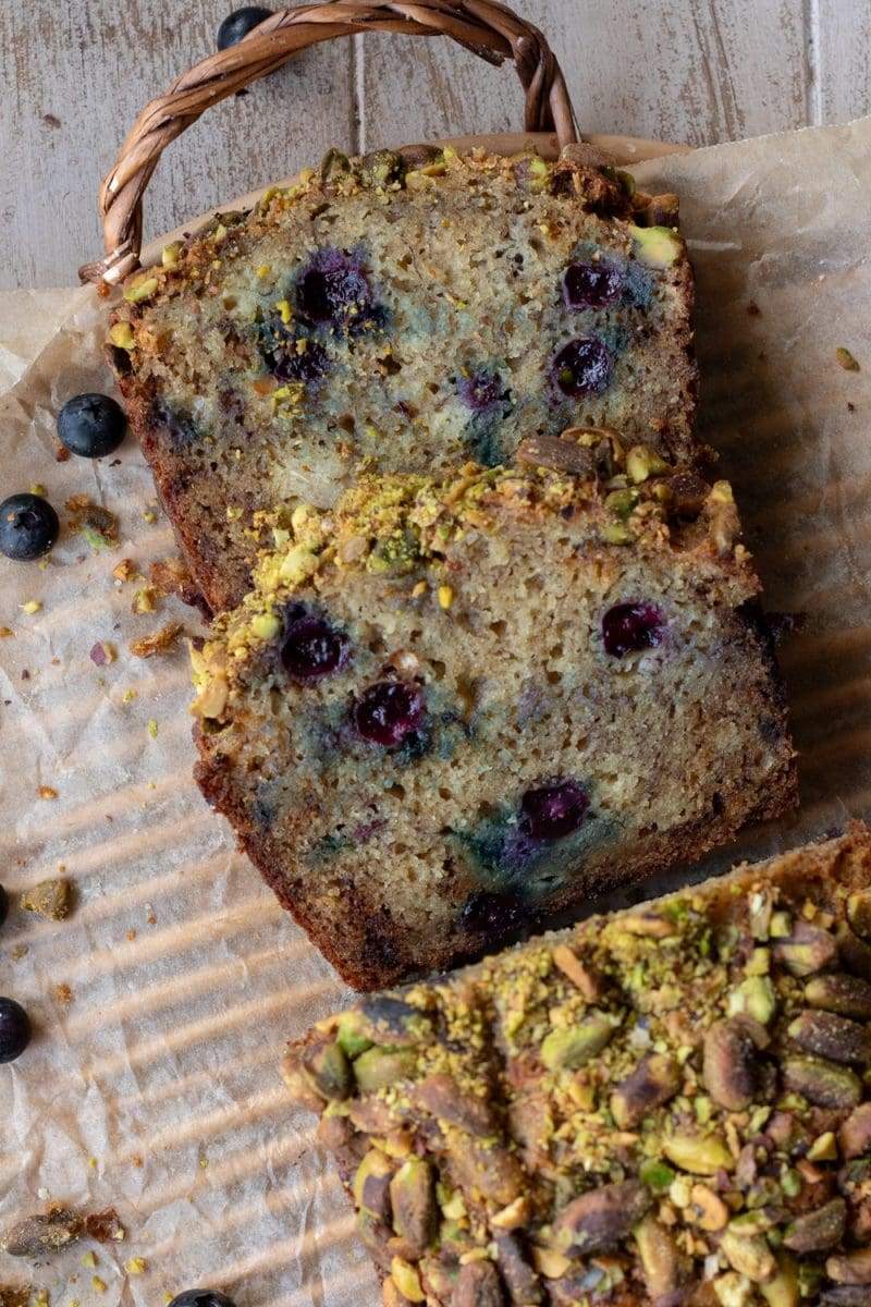 A flat lay of the blueberry banana bread, with two slices layered on top of each other.