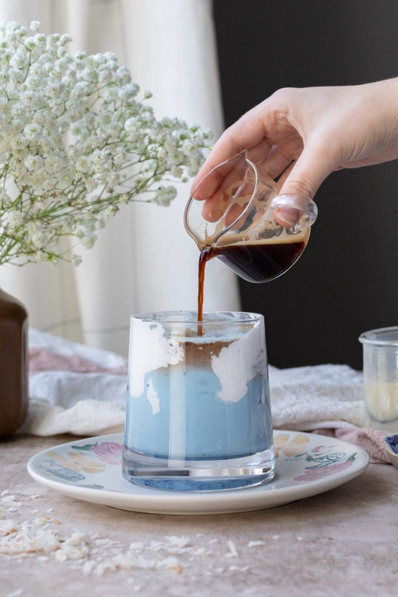 Pouring the espresso into the coconut macchiato