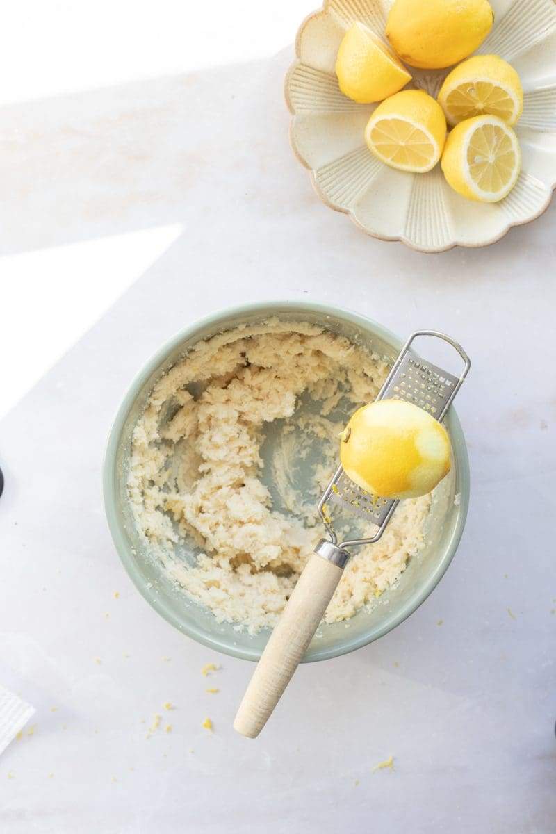 Zesting the lemon into a mixing bowl for the cake batter.