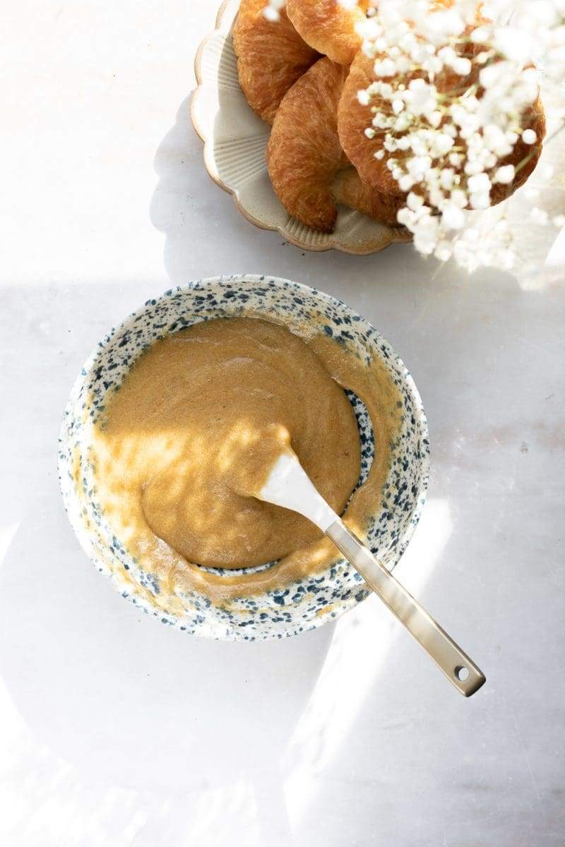 a mixing bowl with the brown butter, sugars, egg, and rose water combined