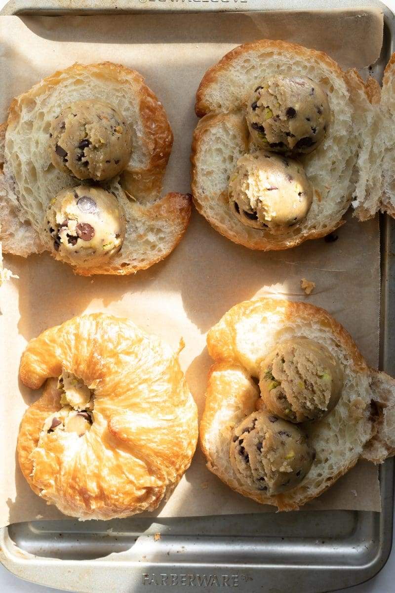 cookie dough balls placed in the middle of the cut-open croissants