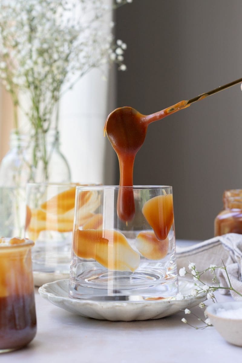 Pouring caramel into the cup.
