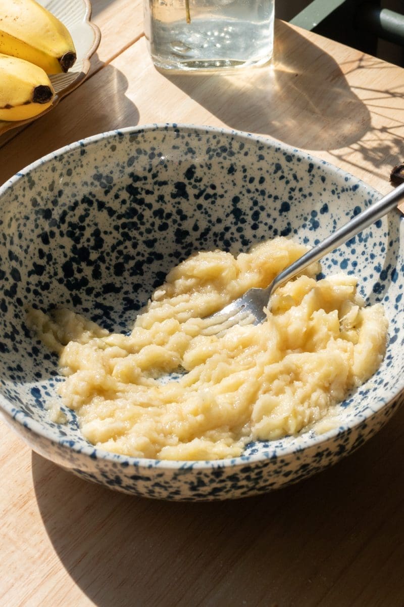 The mashed banana in a mixing bowl.