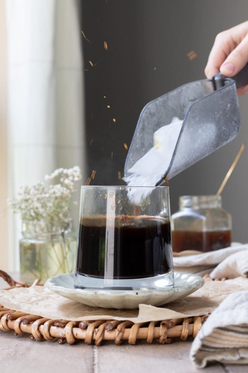 Pouring ice into a cup.