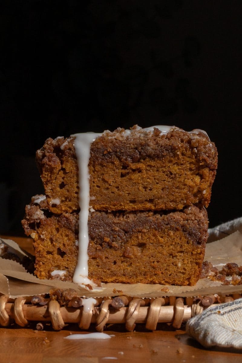 Close up of two pieces of pumpkin coffee cake stacked up on top of each other.