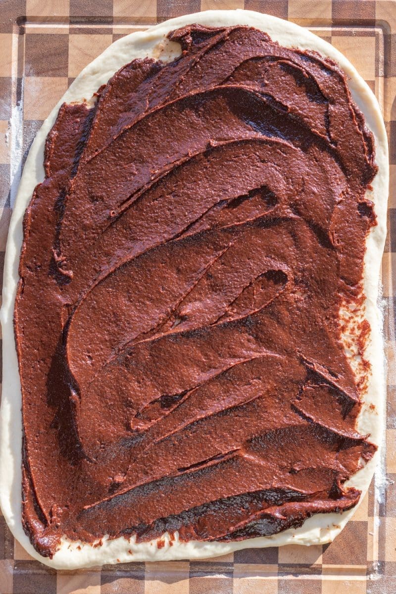 The brownie batter spread out on top of the dough.