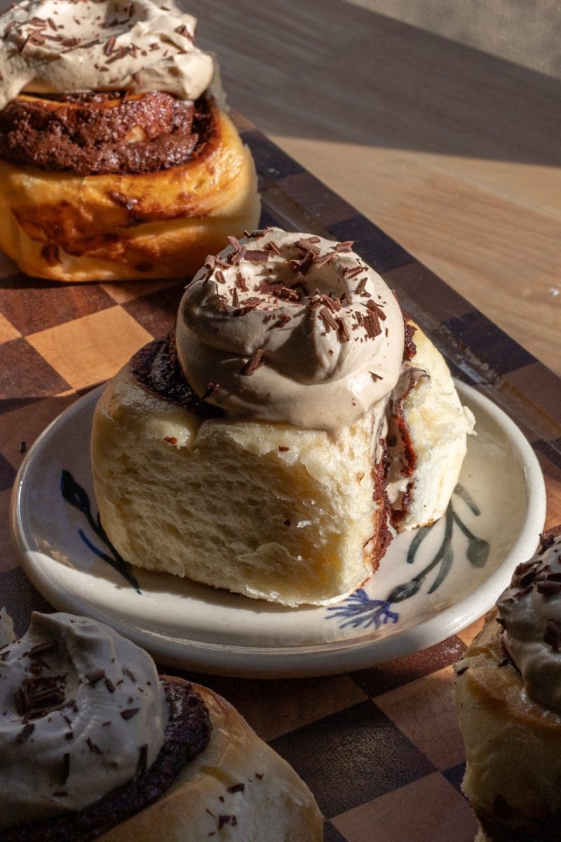 Close up of one of the frosted brioche brownie rolls.