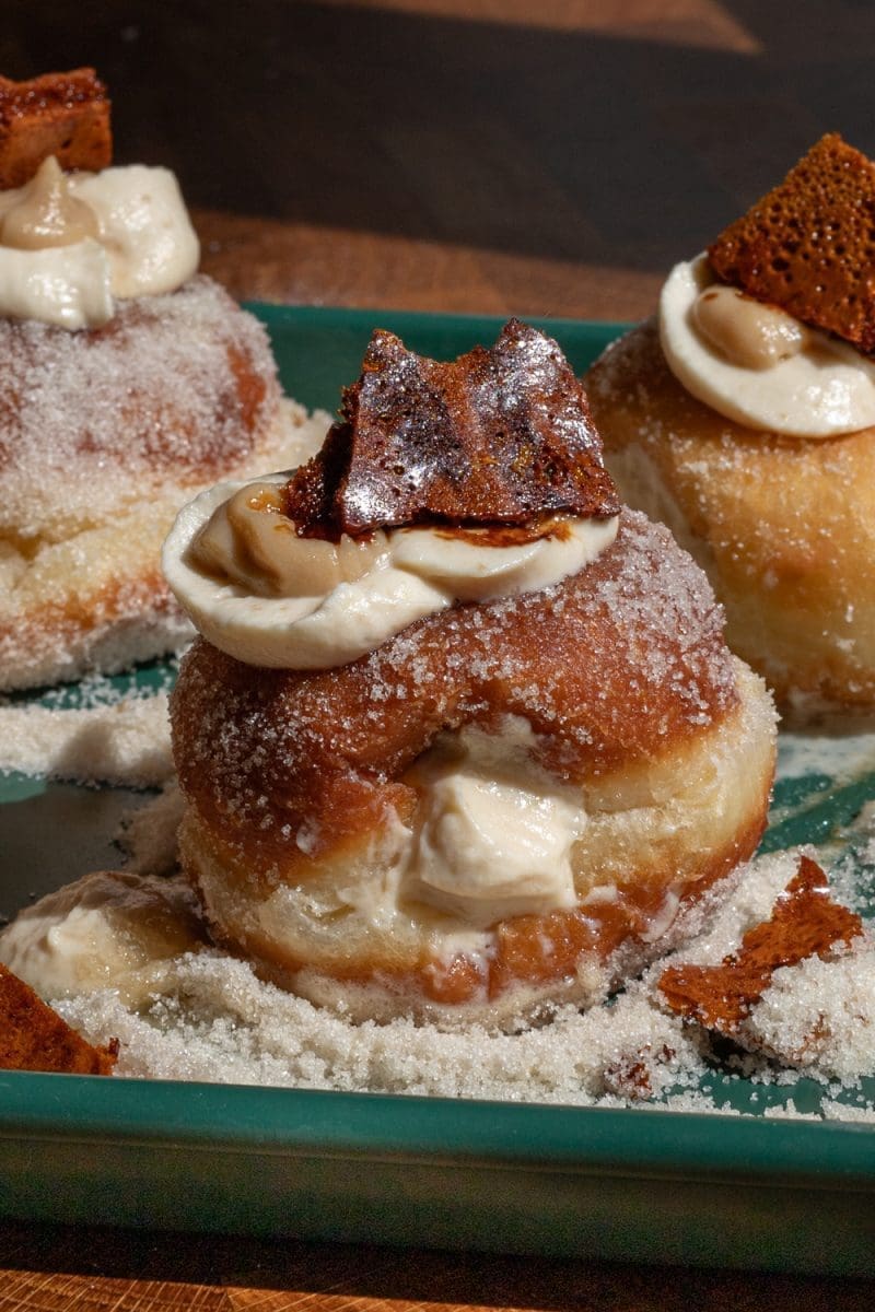 Close up of a filled burnt honey brioche donut.