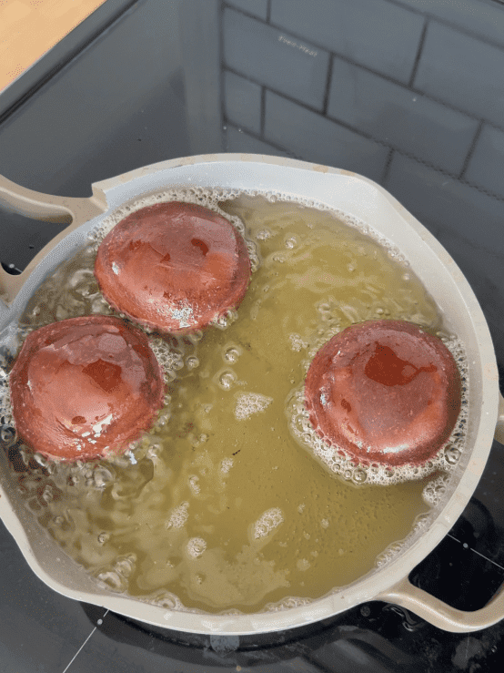 Frying the donuts.