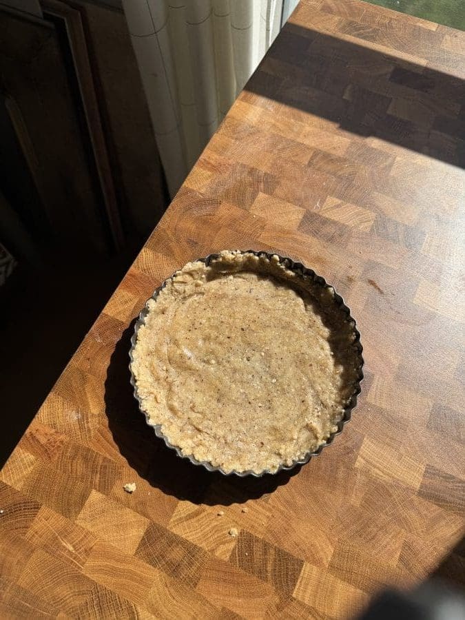The hazelnut shortbread crust pressed into a tart pan.