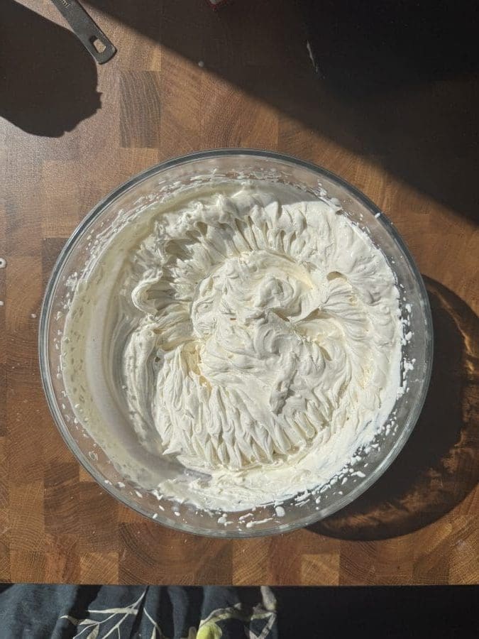 Whipped cream in a mixing bowl.