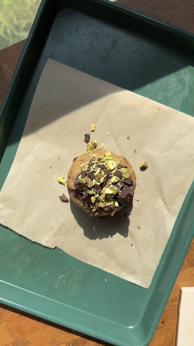 The single cookie dough ball on a baking tray.