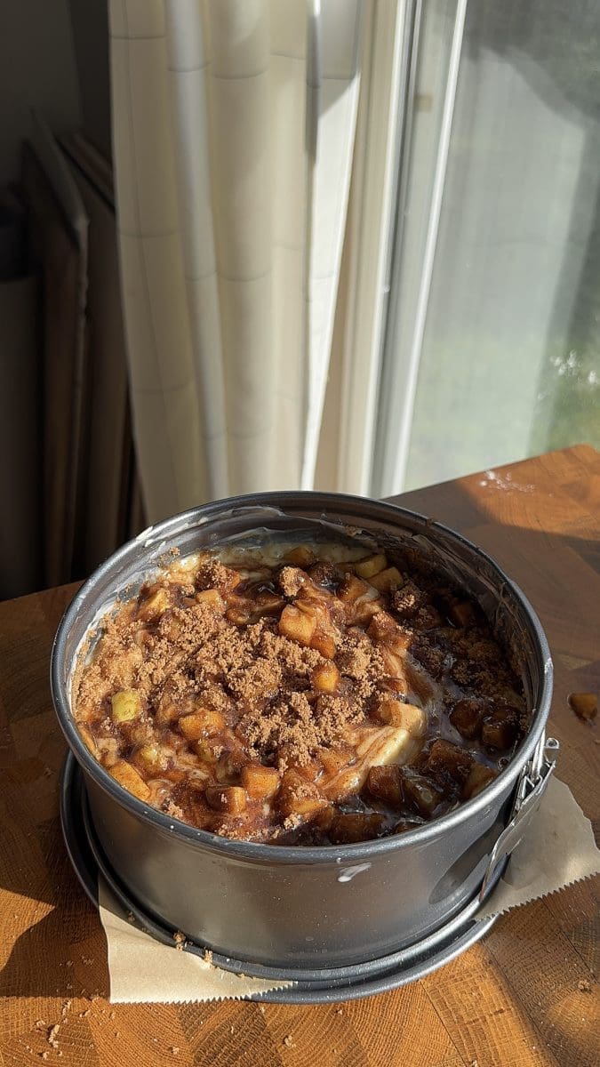 Layering the apple cake batter, apple filling, and apple spiced sugar.
