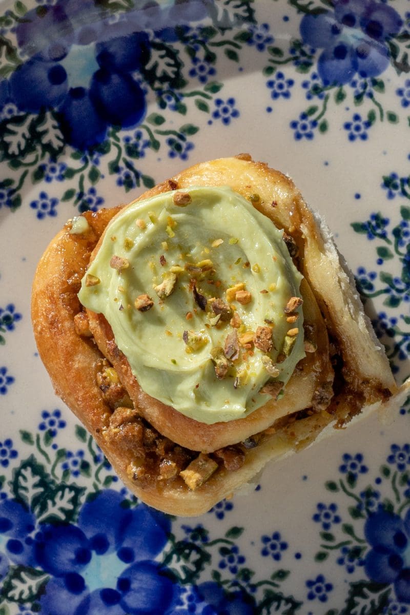 Close up of one of the small batch pistachio cinnamon rolls.