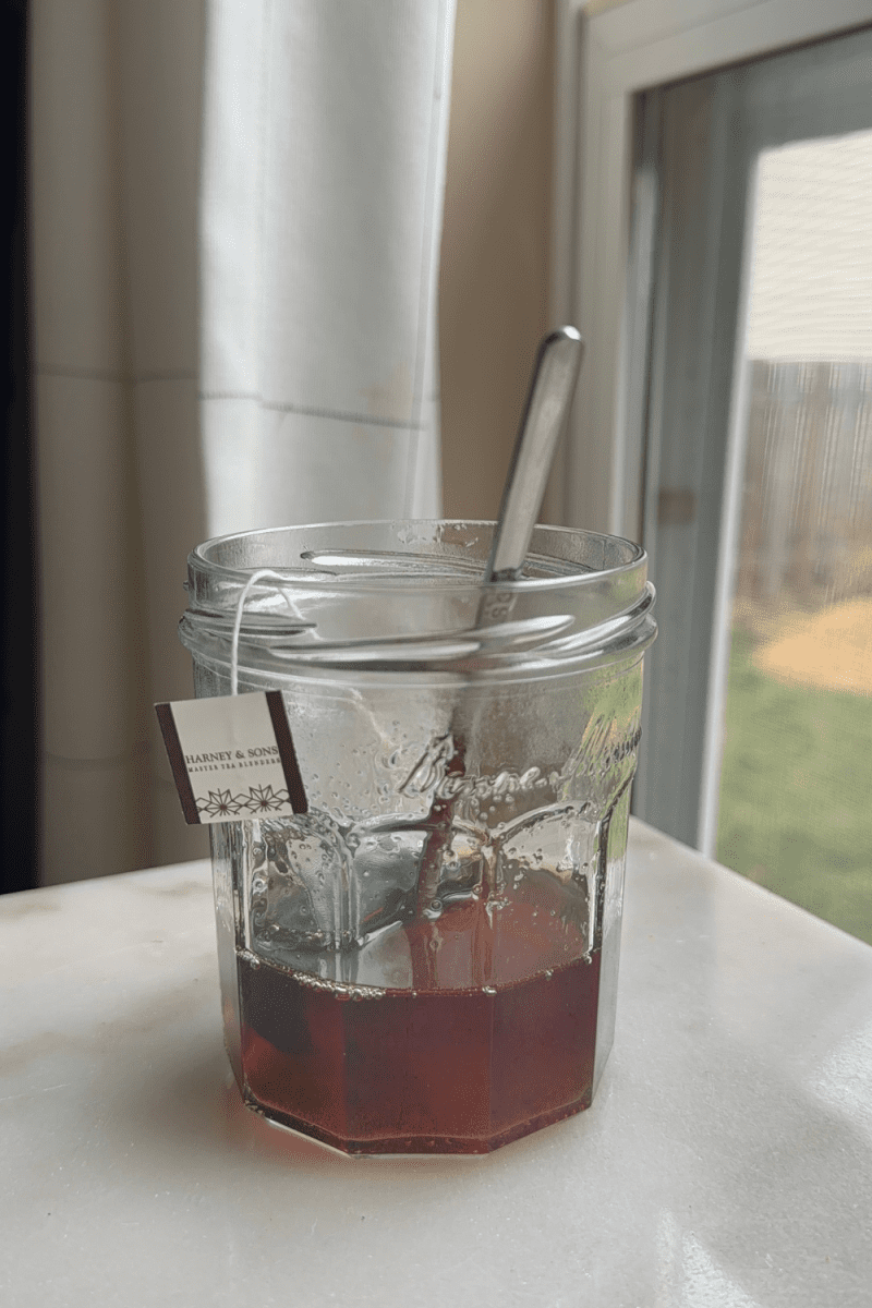The earl grey simple syrup in a small cup.