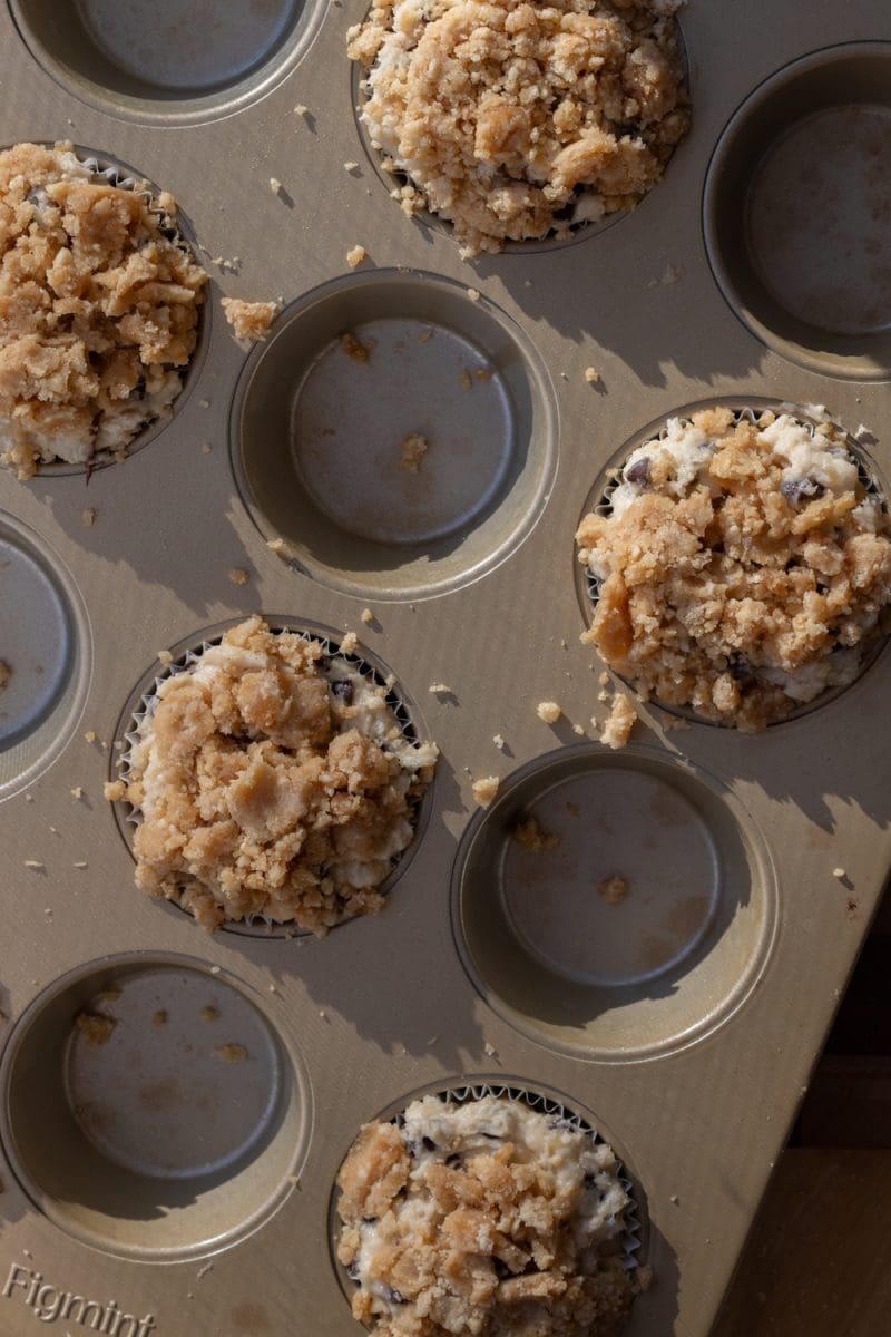 The muffin batter split between six muffin liners.