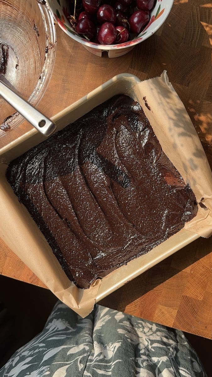 The brownie batter in a square pan.