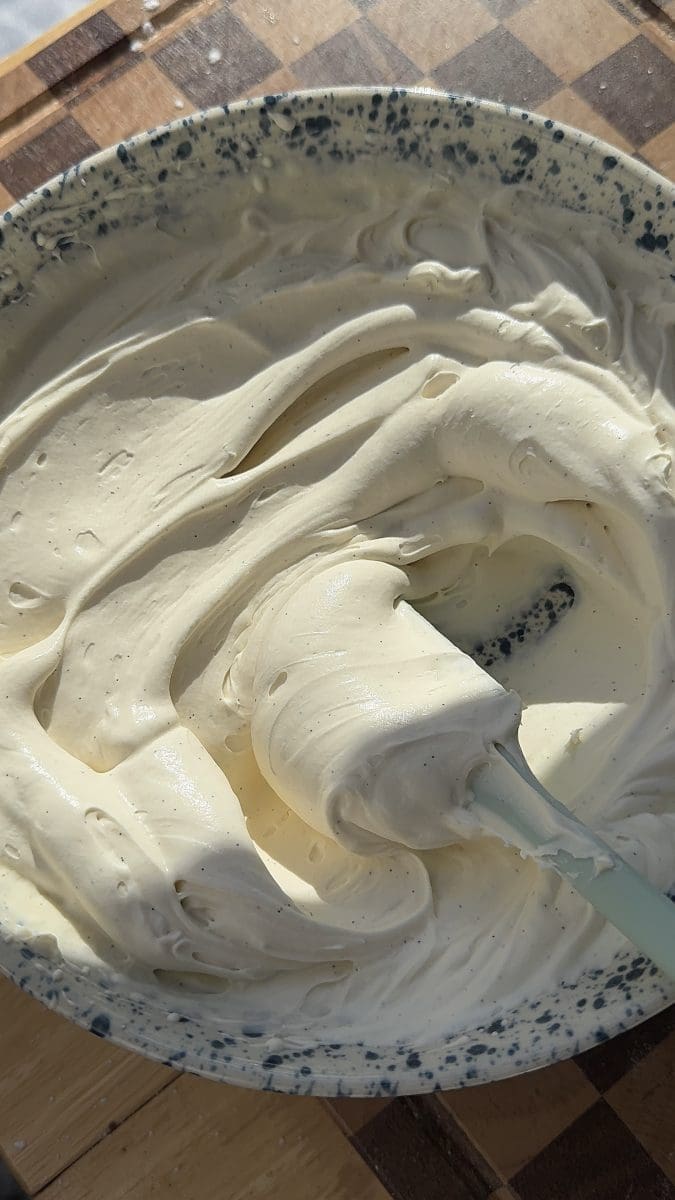 Mascarpone whipped cream in a mixing bowl.