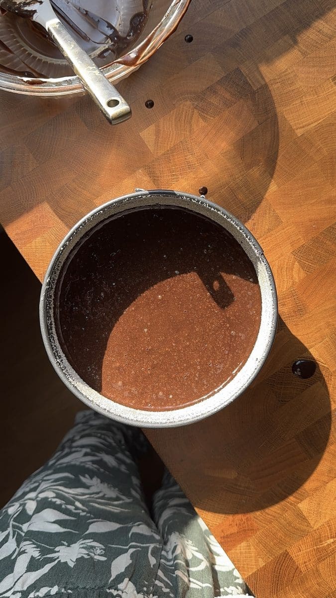 The chocolate cake batter in a springform pan.