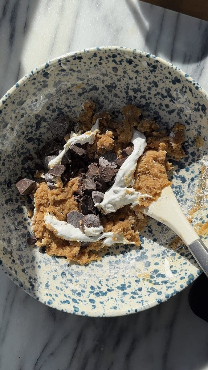 The cookie dough with ribbons of marshmallow fluff on top of it.