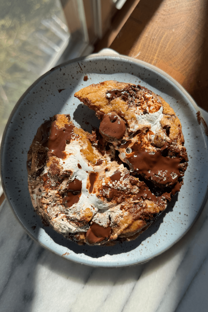 The single serve pumpkin chocolate chip cookie broken in half.