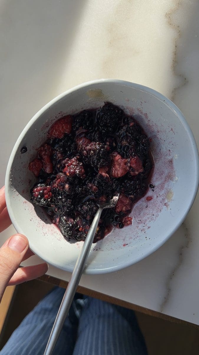 The mixed berries mashed in a small bowl.